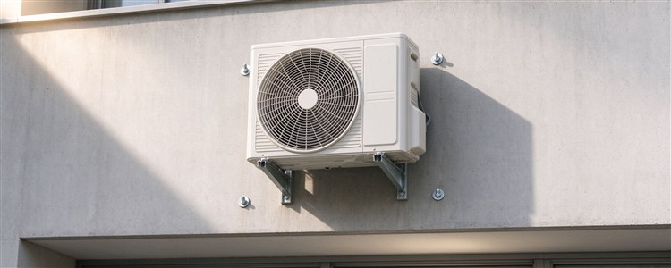 Outdoor AC unit bracket fixed to a wall with expansion bolts
